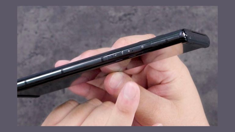 LG Rollable in hand with close up on volume rocker and power button