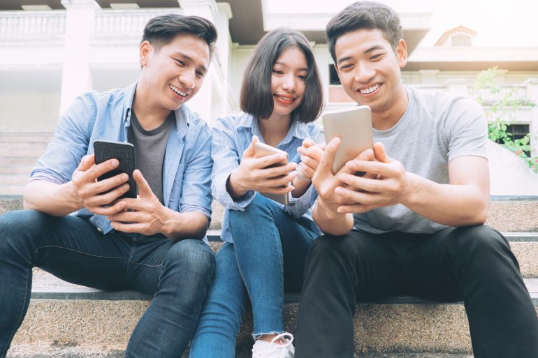 Group of young teen using mobile phones.